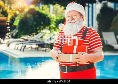 Santa Claus near the pool holiday vacation concept Stock Photo