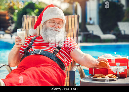 Santa Claus near the pool holiday vacation concept Stock Photo