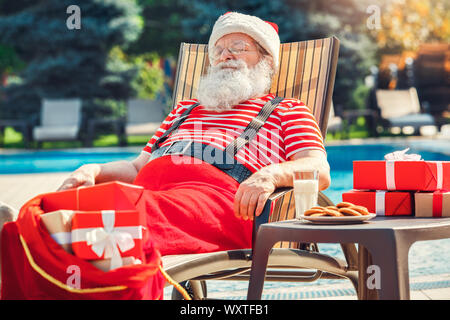 Santa Claus near the pool holiday vacation concept Stock Photo