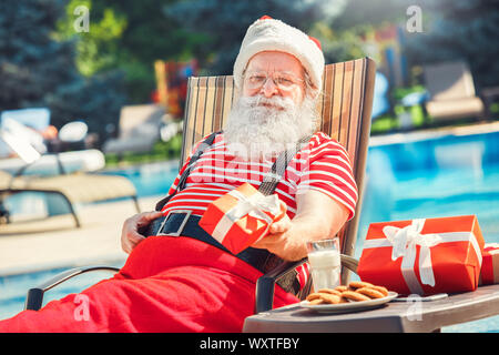 Santa Claus near the pool holiday vacation concept Stock Photo