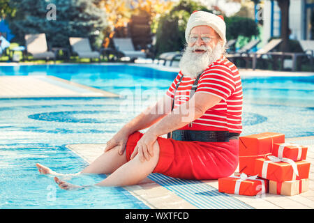 Santa Claus near the pool holiday vacation concept Stock Photo