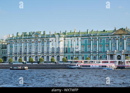 St. Petersburg, Russia, September 2019: Facade of the Winter Palace, Neva River and tourist pleasure boats in St. Petersburg on a warm autumn day Stock Photo