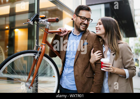 Young couple having fun in the city and ride a bicycle Stock Photo