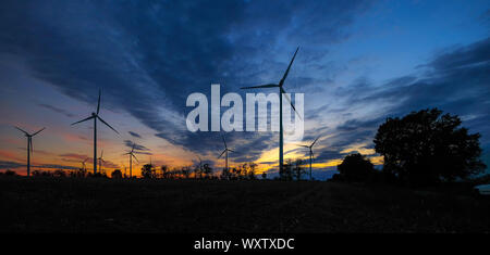 Sunset and windmills on a summer evening Stock Photo