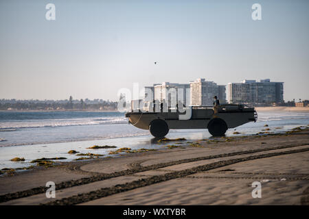 190914-N-DY073-0028 CORONADO, Calif. (September 14, 2019) A Beach Master Unit One Lighter Amphibious Resupply Cargo (LARC) vehicle drives into the water to receive conduit for Offshore Petroleum Discharge System operations for the Arctic Expeditionary Capabilities Exercise (AECE). Approximately 3,000 U.S. Navy and Marine Corps personnel participate in AECE 2019, a joint training exercise that tests expeditionary logistical capabilities in the Arctic and Southern California regions and prepares joint forces to respond to crises across the Indo-Pacific. (U.S. Navy photo by Mass Communication Spe Stock Photo