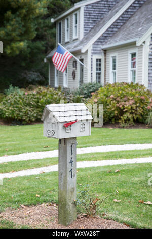 American flag flying and traditional clapboard architecture house and postbox near Cockle Cove at Chatham, Cape Cod, New England, USA Stock Photo