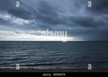 Moody sky over Cape Cod Bay, the Atlantic Ocean by Provincetown, Cape Cod, New England, USA Stock Photo