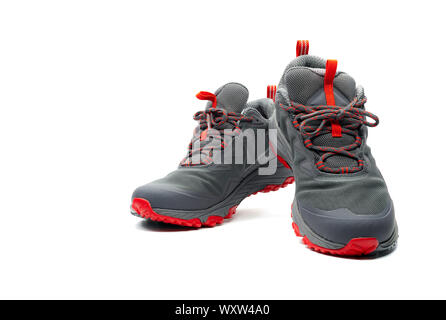 Men trekking shoes isolated on white background. Gray-red hiking shoes. Safety footwear for climbing. Adventure gear. Lightweight rubber trekking shoe Stock Photo