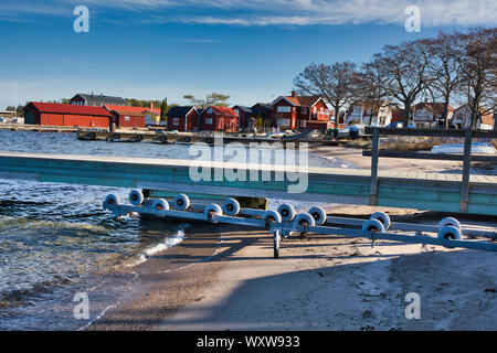 Beach with jetty on the Stockholm archipelago island of Sandhamn in winter, Sweden Stock Photo
