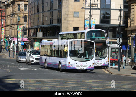 Two buses on Bridge Street in Bradford city centre. First Bradford single deck bus and First Bradford Volvo double deck bus on 17th September 2019. Stock Photo