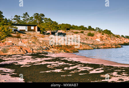 Summer cabin on rocky headland above beach and Baltic sea, Sandhamn island, Stockholm archipelago, Sweden Stock Photo