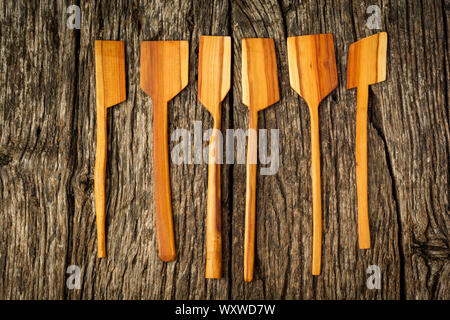 different kitchen wooden utensils close up on rustic wooden background. Stock Photo