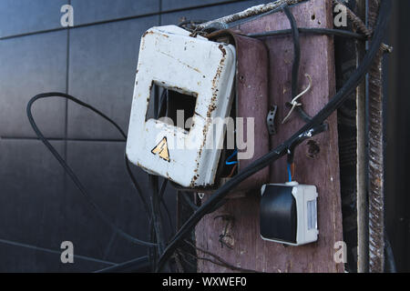 Self made rusty electric box. Energized electrical equipment. Dangerous, high voltage! Stock Photo