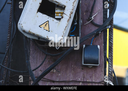 Self made rusty electric box. Energized electrical equipment. Dangerous, high voltage! Stock Photo