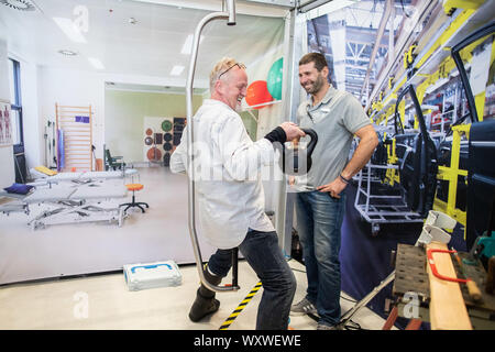 Duesseldorf, Germany. 18th Sep, 2019. Peter Lammer (l), gastronome and cook from Salzburg, presents the standing and moving aid 'Standing Ovation'. To his right is the technical manager Bernhard Tichy. The fair presents possibilities to lead a largely self-determined life despite disability with the help of innovative rehabilitation technology. Around 700 exhibitors from over 40 countries will be taking part. Credit: Marcel Kusch/dpa/Alamy Live News Stock Photo