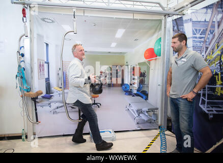 Duesseldorf, Germany. 18th Sep, 2019. Peter Lammer (l), gastronome and cook from Salzburg, presents the standing and moving aid 'Standing Ovation'. To his right is the technical manager Bernhard Tichy. The fair presents possibilities to lead a largely self-determined life despite disability with the help of innovative rehabilitation technology. Around 700 exhibitors from over 40 countries will be taking part. Credit: Marcel Kusch/dpa/Alamy Live News Stock Photo