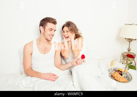Young man making a proposal in bed Stock Photo
