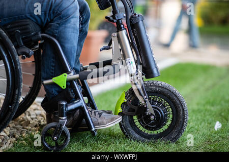 Duesseldorf, Germany. 18th Sep, 2019. A wheelchair with a towing device stands on a wheelchair test track. 'Triride' is a light towing device that can be coupled to manual wheelchairs. The fair presents possibilities to lead a largely self-determined life despite disability with the help of innovative rehabilitation technology. Around 700 exhibitors from over 40 countries will be taking part. Credit: Marcel Kusch/dpa/Alamy Live News Stock Photo