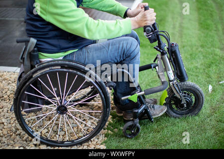 Duesseldorf, Germany. 18th Sep, 2019. A wheelchair with a towing device stands on a wheelchair test track. 'Triride' is a light towing device that can be coupled to manual wheelchairs. The fair presents possibilities to lead a largely self-determined life despite disability with the help of innovative rehabilitation technology. Around 700 exhibitors from over 40 countries will be taking part. Credit: Marcel Kusch/dpa/Alamy Live News Stock Photo