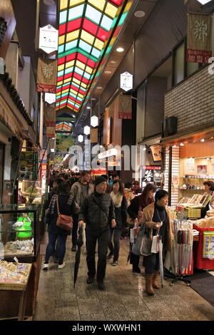 KYOTO, JAPAN - NOVEMBER 27, 2016: People shop at Nishiki Market in Kyoto, Japan. Nishiki is a popular traditional food market in Kyoto. Stock Photo