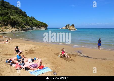 CORFU, GREECE - MAY 31, 2016: People enjoy the beach in Sidari, Corfu Island, Greece. 558,000 tourists visited Corfu in 2012. Stock Photo