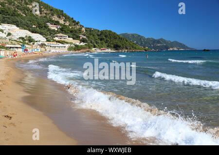 CORFU, GREECE - JUNE 3, 2016: Tourists enjoy the beach in Pelekas, Corfu Island, Greece. 558,000 tourists visited Corfu in 2012. Stock Photo