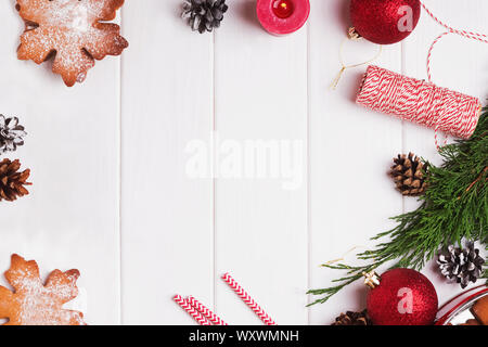 Decorative Christmas composition with gingerbread snowflake cookies, pine cones, red balls and other decor Stock Photo