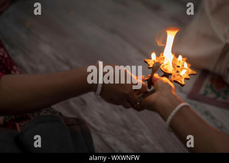 Burning oil lamp or pancha pradip with fire flame coming out - Background picture of Indian Hindu tradition & cultural ritual for worshiping god with Stock Photo