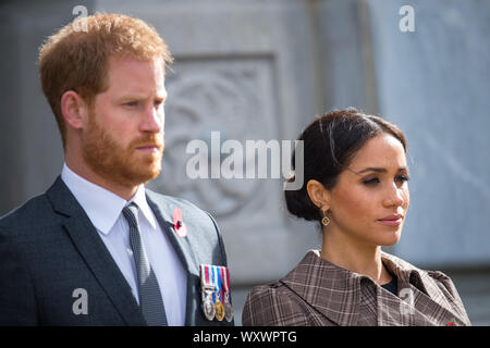 Prince Harry, Duke of Sussex and Meghan, Duchess of Sussex lay ferns and a wreath at the tomb of the Unknown Warrior while they visit the newly unveiled UK war memorial and Pukeahu National War Memorial Park on October 28, 2018, in Wellington, New Zealand. Stock Photo