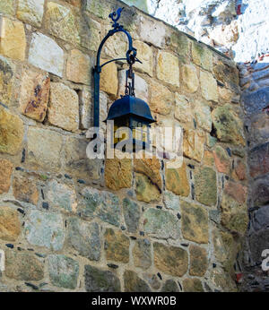 old lantern on brick wall of old castle Stock Photo