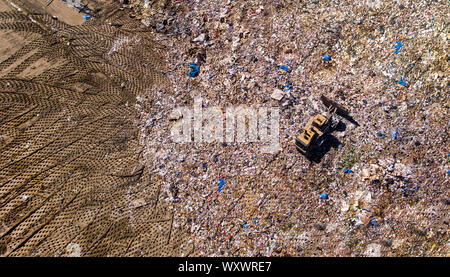 trash being worked at the landfill by heavy equipment Stock Photo