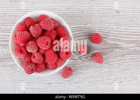 Raspberry fruit closeup isolated on wooden background Stock Photo