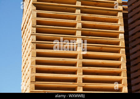 stacked wooden pallets, blue sky