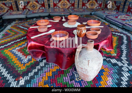 Old style table, floor table in a tent Stock Photo