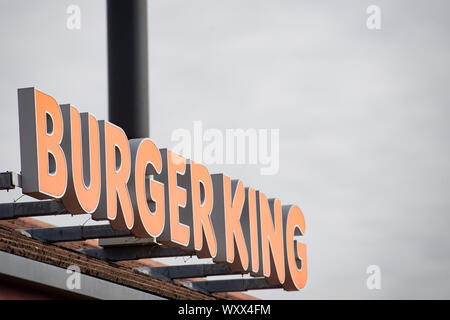 A sign for a Burger King drive thru restaurant. The fast food chain has announced that they are removing all plastic toys from its children's meals served in the UK from Thursday to save an estimated 320 tonnes of waste annually. PA Photo. Picture date: Wednesday September 18, 2019. Burger King said the move was part of a wider commitment to reduce its use of plastic, and admitted it was 'spurred on' by Southampton sisters Ella and Caitlin McEwan's petition against the use of plastic toys in children's meals. See PA story CONSUMER BurgerKing. Photo credit should read: Jacob King/PA Wire Stock Photo