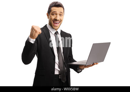 Young businessman gesturing yeah and holding a laptop computer isolated on white background Stock Photo