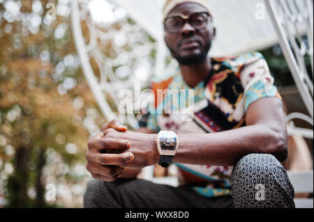 Close up royal watches on hand of rich african american man. Stock Photo