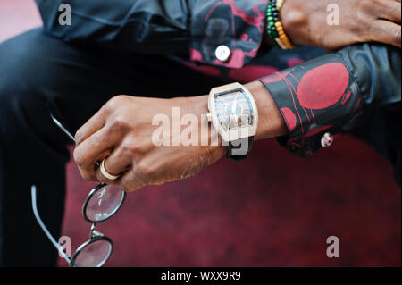 Close up royal watches on hand of rich african american man. Stock Photo