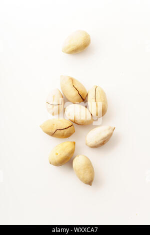 Pecan nuts in nutshells isolated. Overhead image, white background Stock Photo