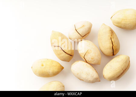 Pecan nuts in nutshells isolated. Overhead image, white background Stock Photo