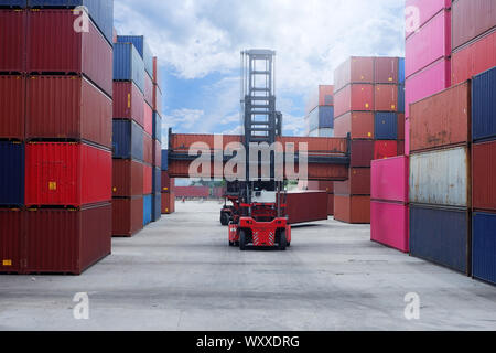 Crane lifter handling container box loading to depot Stock Photo