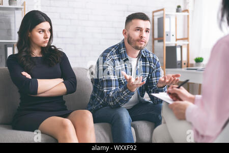 Young man talking to psychotherapist at marital consultation Stock Photo