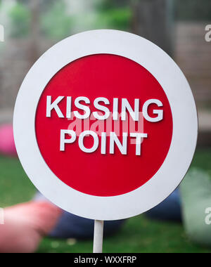 Close up of kissing point sign staying in city park Stock Photo
