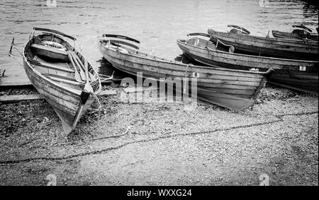 Black white photography of harbour, warf, marina, shore with wooden boats. Lake District, Stock Photo