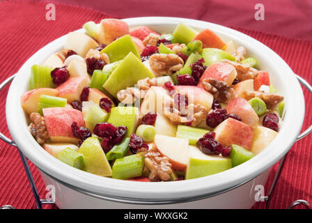 Healthy version of Waldorf salad. Ingredients are granny smith and gala apples, cranberries, celery, spring onion, walnuts with a walnut oil based dre Stock Photo