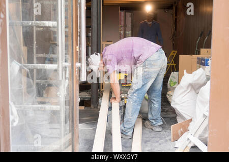 Paris, France - Aug 31, 2019: Two asian men rrenovate the interior of a small shop in Paris, France. Stock Photo