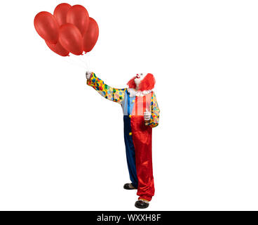 a clown holds red ballons in his hand Stock Photo