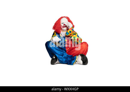 sad clown sitting on the floor and crying Stock Photo