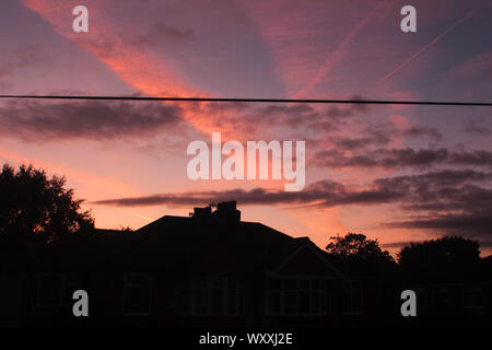 a pretty purple sunset over houses in Manchester Stock Photo