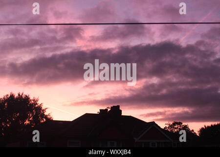 a pretty purple sunset over houses in Manchester Stock Photo